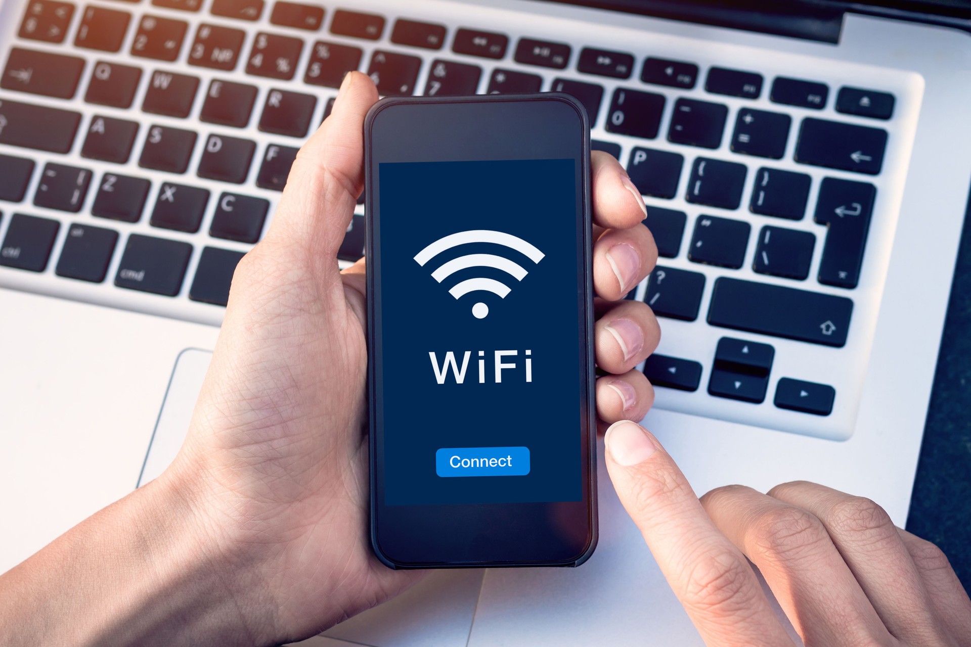 Connect to WiFi wireless internet network with smartphone at coffee shop or hotel with button on mobile device screen, free public hotspot secure access to web for email and website browsing